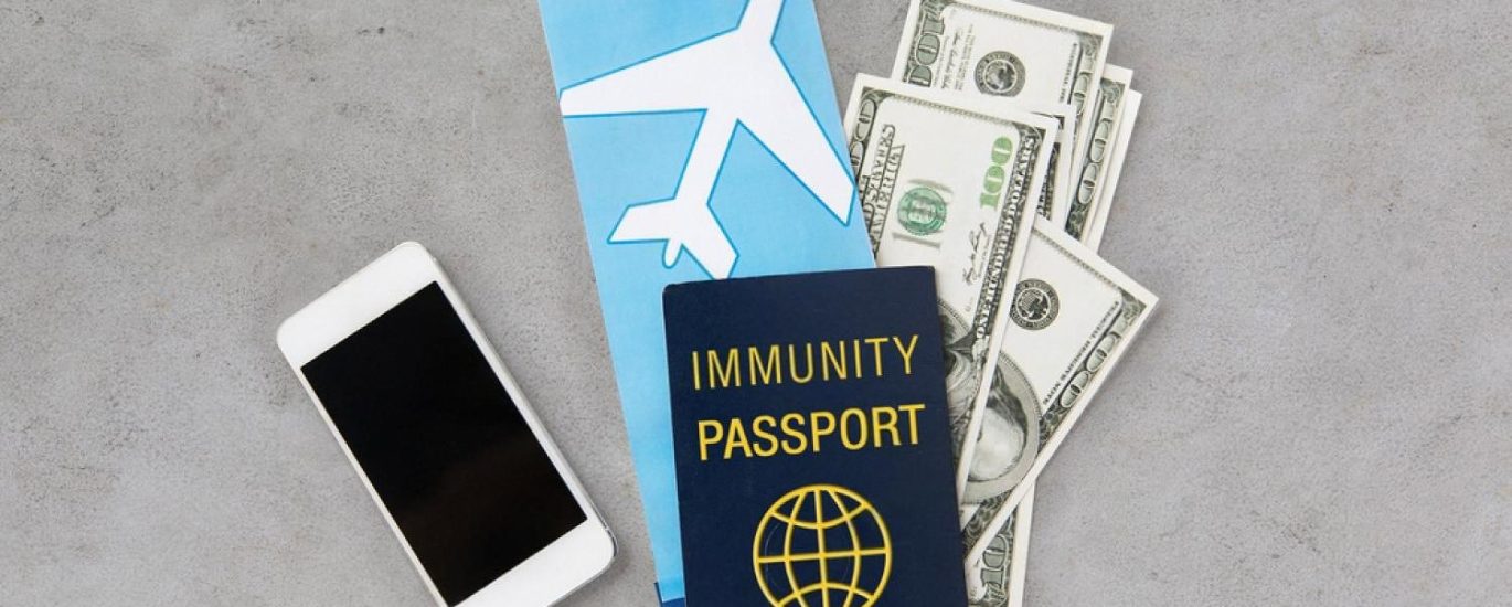 Passport, travel documents and cash arranged on a surface before being placed into a home safe