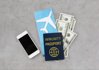 Passport, travel documents and cash arranged on a surface before being placed into a home safe